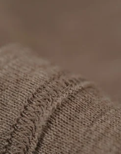 Kjole med flæser i merinould til baby