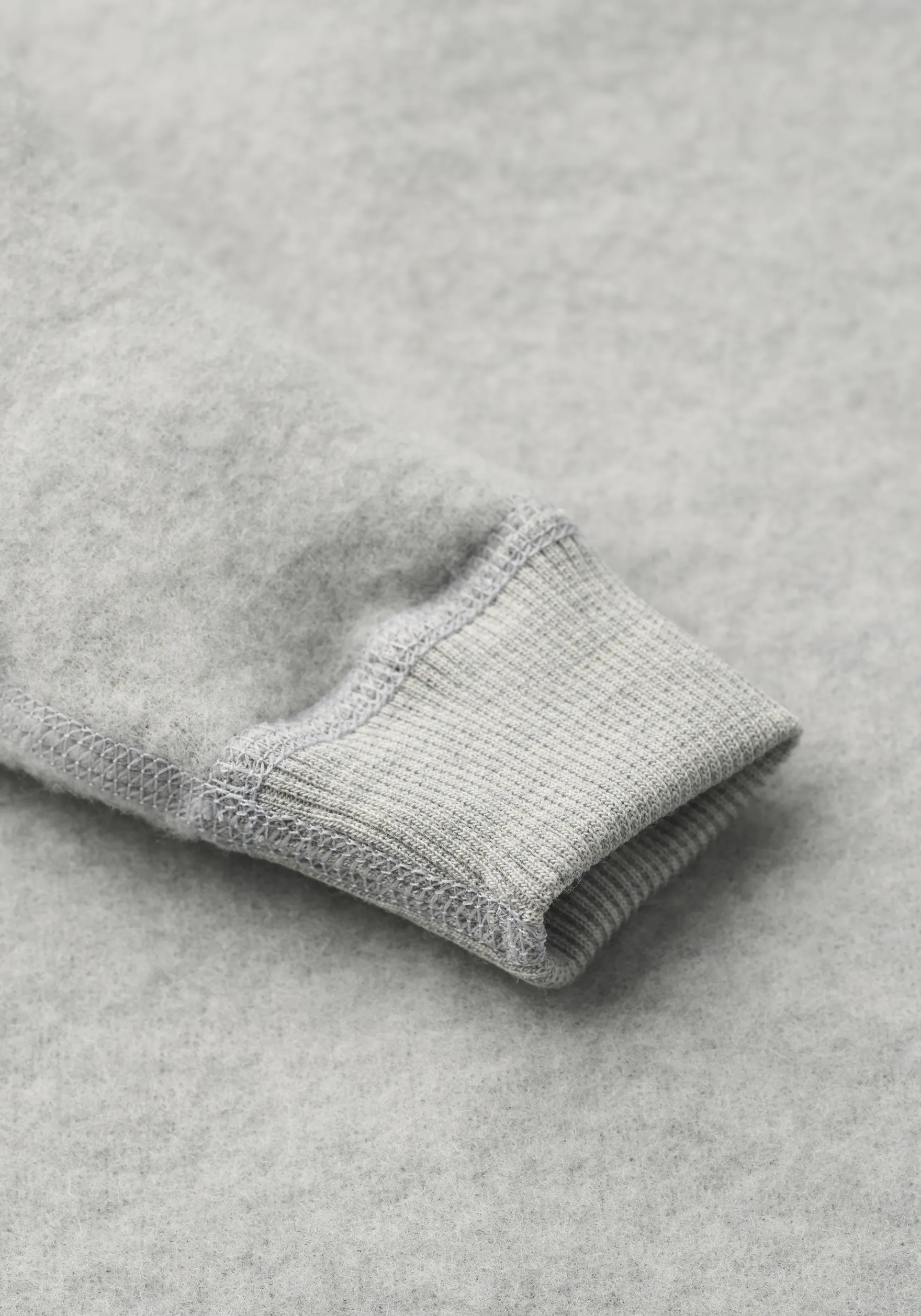 Køredragt med hætte i merinouldfleece til baby