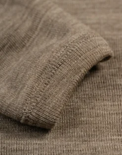 Slå-om-bluse i merinould til baby