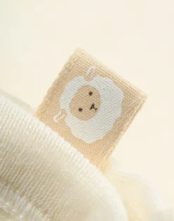Slå-om singlet i merinould/silke til nyfødt